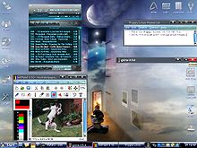 Desktop with one of multiple integrated themes with XMMS a multimedia player, mtPaint a painting program for creating pixel art and manipulating digital photos and mplayer running, plus an opened text file under Puppy Linux 2.15 CE Viz (with default WM: IceWM)